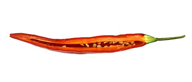 half, cross-sectional hot chili pepper Half, cross sectional hot chili pepper on white background. cayenne pepper photos stock pictures, royalty-free photos & images