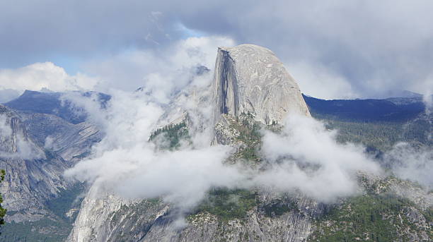 Half Dome Surrounded by White Clouds in Yosemite stock photo