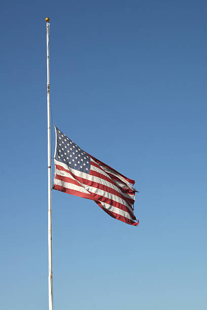 Half Mast US Flag at half mast. flag at half staff stock pictures, royalty-free photos & images