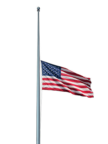 Half Mast US Flag Isolated Half mast American flag isolated concept with the symbol of the United States flying at low level on the flagpole or staff on a white background as an icon of honor respect and mourning for fallen heros. flag at half staff stock pictures, royalty-free photos & images