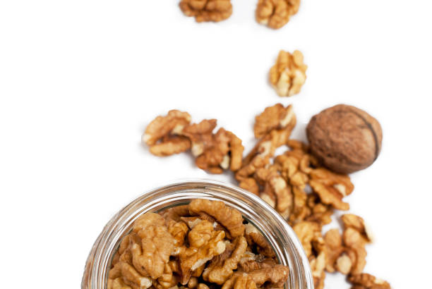 Half of jar with walnuts, view from above stock photo