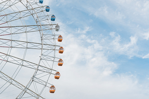 Half of the Ferris wheel against sky.