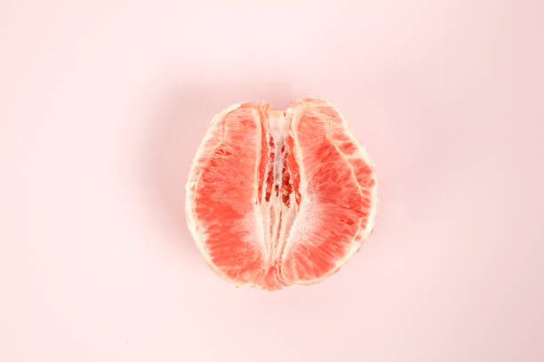 half peeled grapefruit stock photo