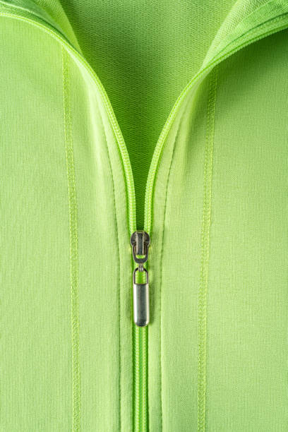 Half zipped cotton sweatshirt hoodie close-up. Fashionable summer light green jacket with zipper fastening. Casual outerwear and trendy clothes in bright colors concepts. Zip fastener of pullover. stock photo