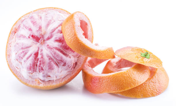 Half-peeled grapefruit isolated on white background. stock photo