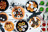 High angle view of various decorated treats for Halloween celebration
