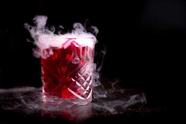 halloween cocktail with dry ice on dark background left side - blood bar imagens e fotografias de stock