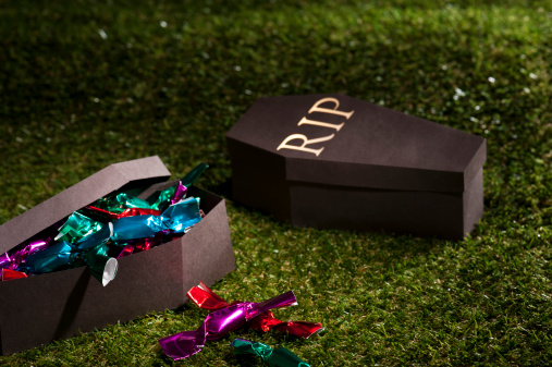 Halloween coffin on lawn with sweets and candies
