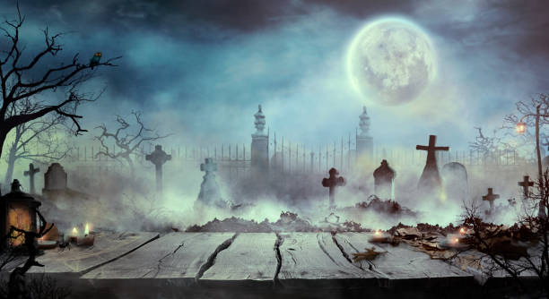 Halloween design with wooden table and graveyard stock photo
