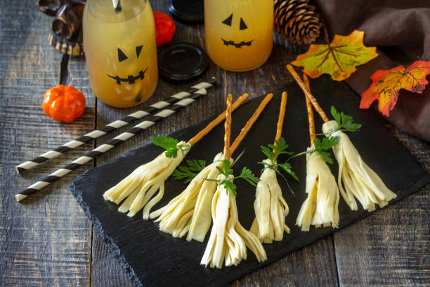 Halloween funny idea for party food. Halloween creative cheese snack on a wooden table. stock photo