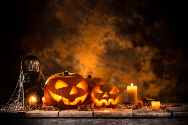 Halloween pumpkins on wooden planks Halloween pumpkins on wooden planks with spooky background. cemetery photos stock pictures, royalty-free photos & images