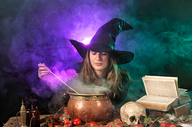 Halloween witch on smoky green and purple background stock photo