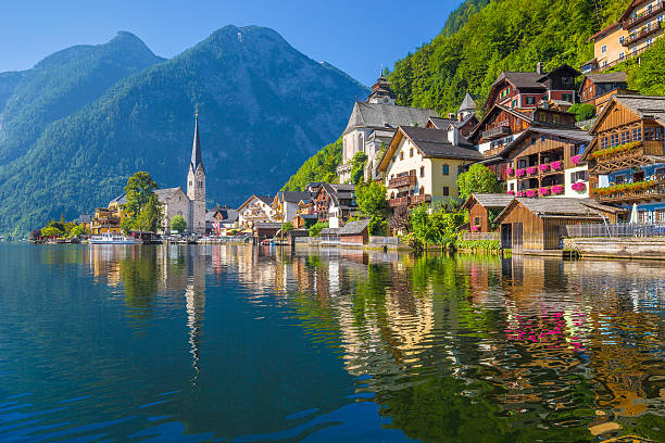 Hallstatt mountain village in the Alps, Salzkammergut, Austria Scenic picture-postcard view of famous Hallstatt village reflecting in Hallstattersee lake in the Austrian Alps in beautiful morning light on a sunny day in summer, Salzkammergut region, Austria. austria stock pictures, royalty-free photos & images