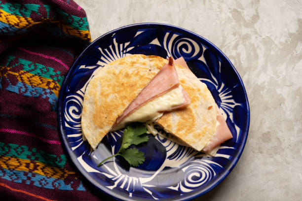 Ham and cheese quesadilla with flour tortilla. Mexican food stock photo