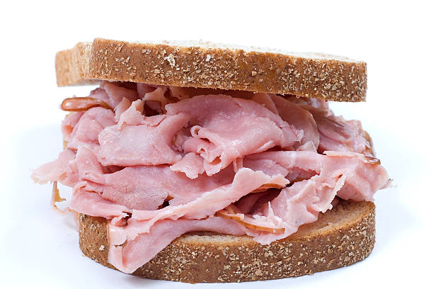 Ham sandwich closeup honey ham wheat bread sandwich in white background chopped food photos stock pictures, royalty-free photos & images