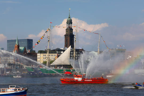 Hamburg Harbor Birthday parade 2017, Germany Hamburg, Germany - May 07, 2017: Hamburg harbor birthday celebration (Hafengeburtstag). One million visitors from around the world joined the world’s greatest port festival. Fire-fighting boat announces the beginning of the final ship-parade. Michel Church (Michaelis Church) and the tall ship Rickmer Rickmers in the background. fire extinguishers on boat stock pictures, royalty-free photos & images