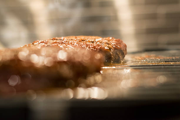 Hamburger Meat on Grill indoors stock photo