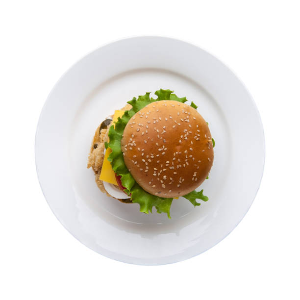 hamburger on a white plate hamburger with lettuce in a plate on a white background, top view high section stock pictures, royalty-free photos & images