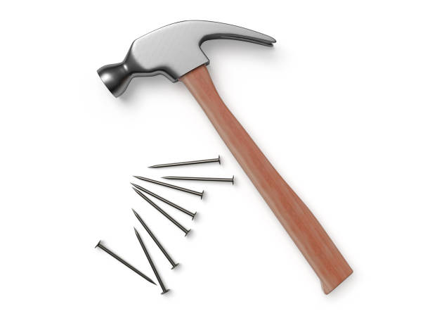 Hammer and nails on white surface. 3D rendering. stock photo