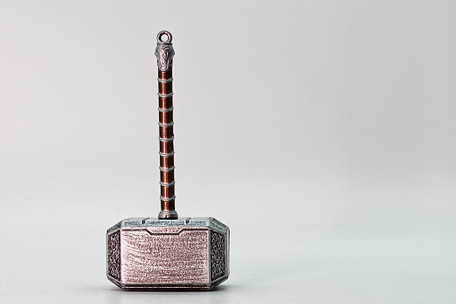 Hammer of Thor, Mjolnir, isolated on white background. The mythical Thors hammer. Thor the God of thunder for Viking people. Mjolnir a legendary Viking weapon. Empty space for text