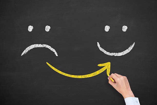 Hand drawing unhappy and happy smileys on blackboard background Hand drawing unhappy and happy smileys on blackboard background depression land feature stock pictures, royalty-free photos & images