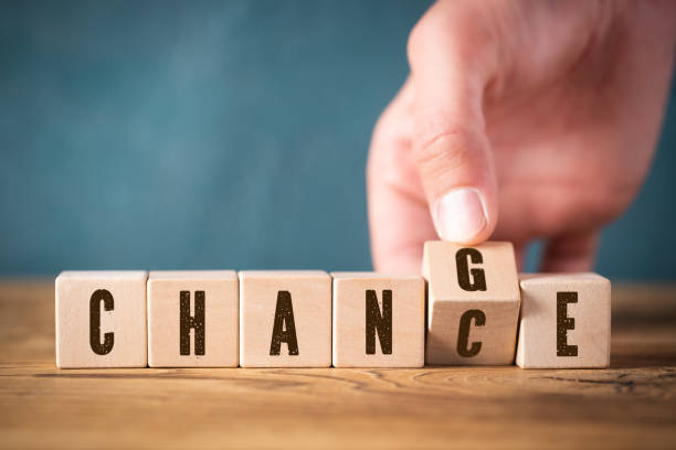 hand flipping one of six cubes, turning the word "change" to "chance" stock photo