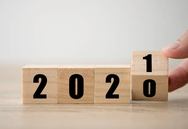 Hand flipping wooden blocks for change year  2020 to 2021 . New year and holiday concept. Hand flipping wooden blocks for change year  2020 to 2021 . New year and holiday concept. the end stock pictures, royalty-free photos & images