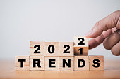 istock Hand flipping wooden cube block for change 2021 to 2022 trend concept. 1359820424