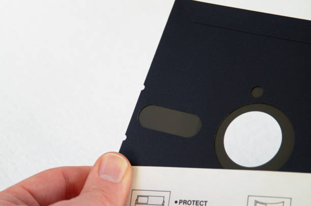 Hand holding 5.25 inch floppy disk stock photo