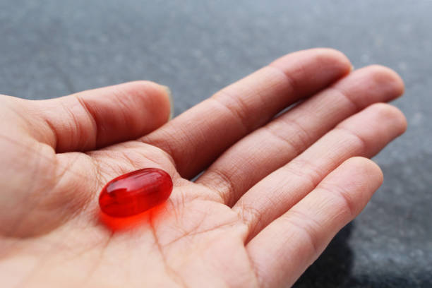 Hand Holding A Red Pill