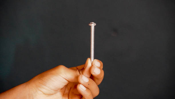 hand holding a Screw stock photo