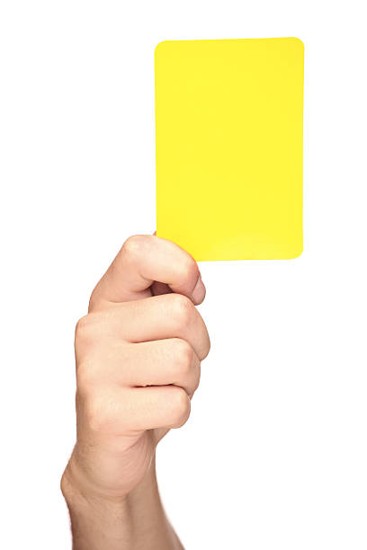 hand holding a yellow card - gele kaart stockfoto's en -beelden