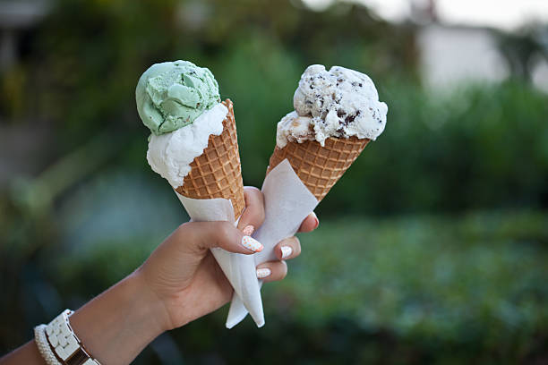 hand holding an ice cream cones stock photo