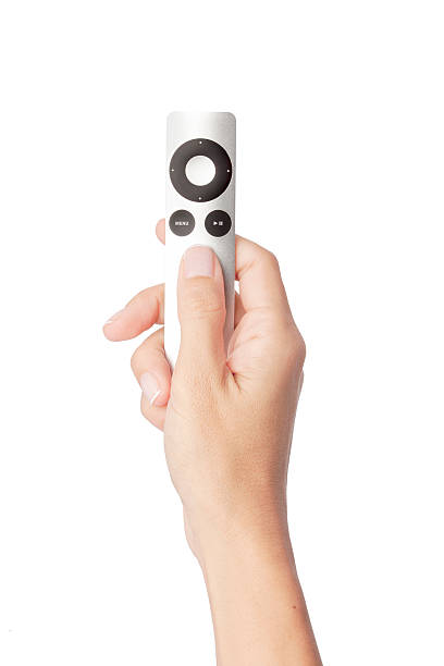 hand holding apple tv remote control stock photo