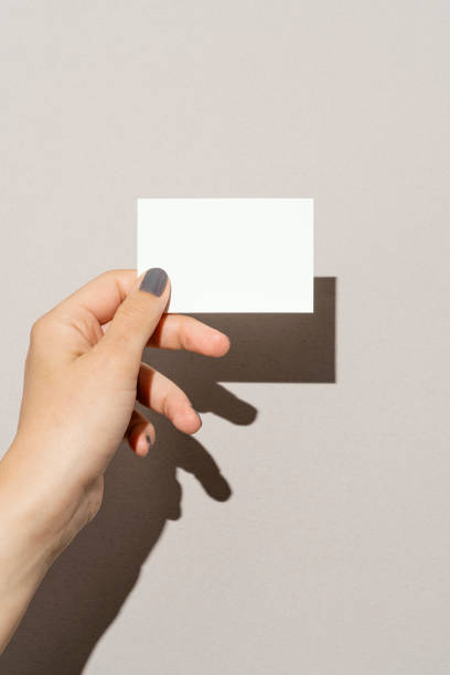 Hand holding blank business card stock photo