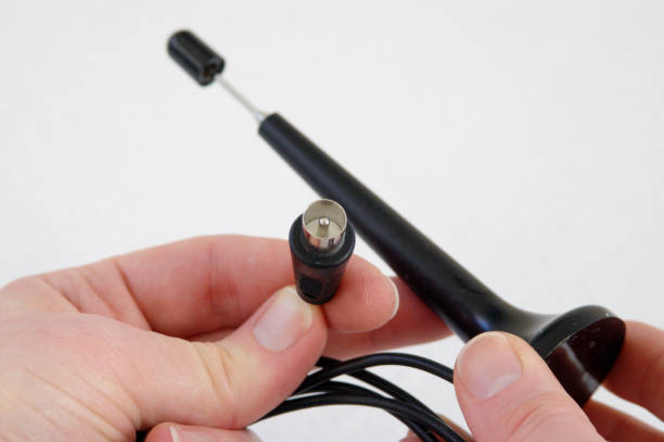 Hand holding Coax antenna connector of a DVB-T pig antenna stock photo