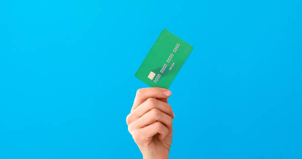 Hand holding credit cards and showing it Hand holding mockup credit cards and showing on the blue background pile of credit cards stock pictures, royalty-free photos & images