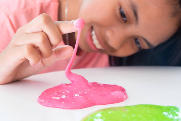 Hand Holding Homemade Toy Called Slime, Kids having fun and being creative by science experiment. stock photo