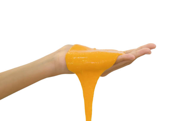 Hand Holding Homemade Toy Called Slime, Teenager having fun and being creative homemade slime. stock photo