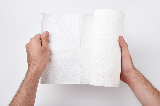 Hand holding paper towel on the white background, male hand using paper towel