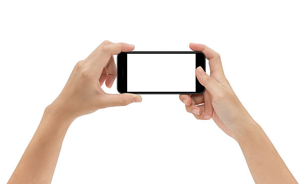hand holding phone isolated on white background hand holding phone isolated on white background, mock-up smart phone matte black color mobile phone photos stock pictures, royalty-free photos & images