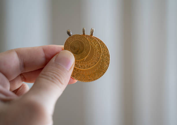 Hand holding Turkish gold coin, Close up stock photo
