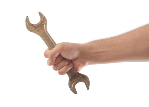 hand holding wrench tool isolated stock photo