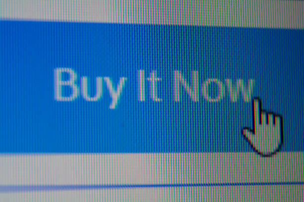 Hand mouse cursor on Buy it now Button stock photo