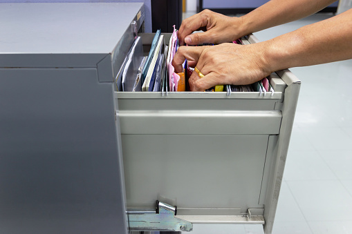 Hand Of Man Search Files Document In A File Cabinet In Work Office Stock Photo Download Image Now Istock