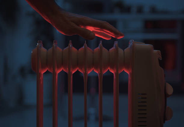 Hand over a warm heater stock photo