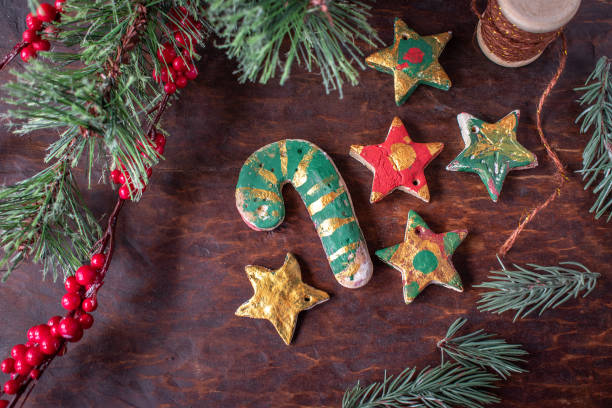 hand painted Christmas salt dough ornaments hand painted Christmas salt dough ornaments on festive wood table dough stock pictures, royalty-free photos & images
