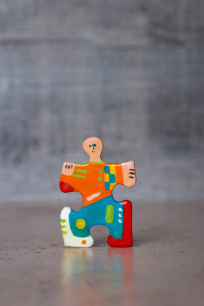 Hand painted jigsaw puzzle piece figure stock photo
