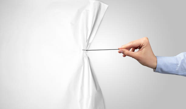 hand pulling white paper curtain stock photo
