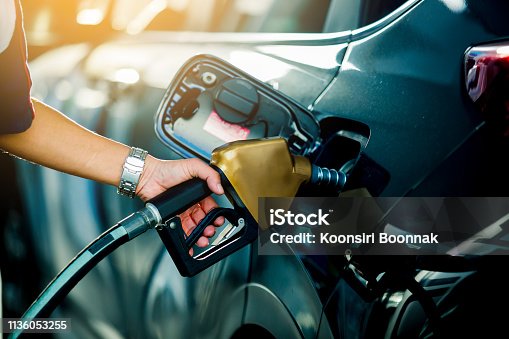 istock Hand refilling the car with fuel at the refuel station 1136053255